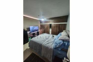 Bedroom with wood wardrobe, mounted TV in duplex house Panama Pacifico