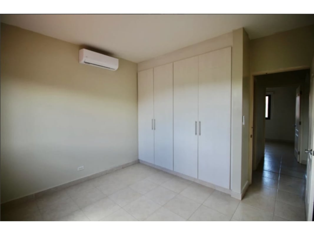 Bedroom with built-in closet, split AC and tile floors in Costa Sur Panama City home