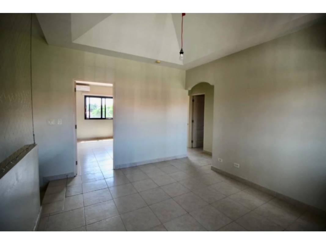 Kitchen with granite counters, breakfast bar, wood cabinets in Costa Sur residential community
