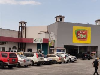 Wide empty commercial interior with ceramic tile floor and white walls at Las Mañanitas Panama City