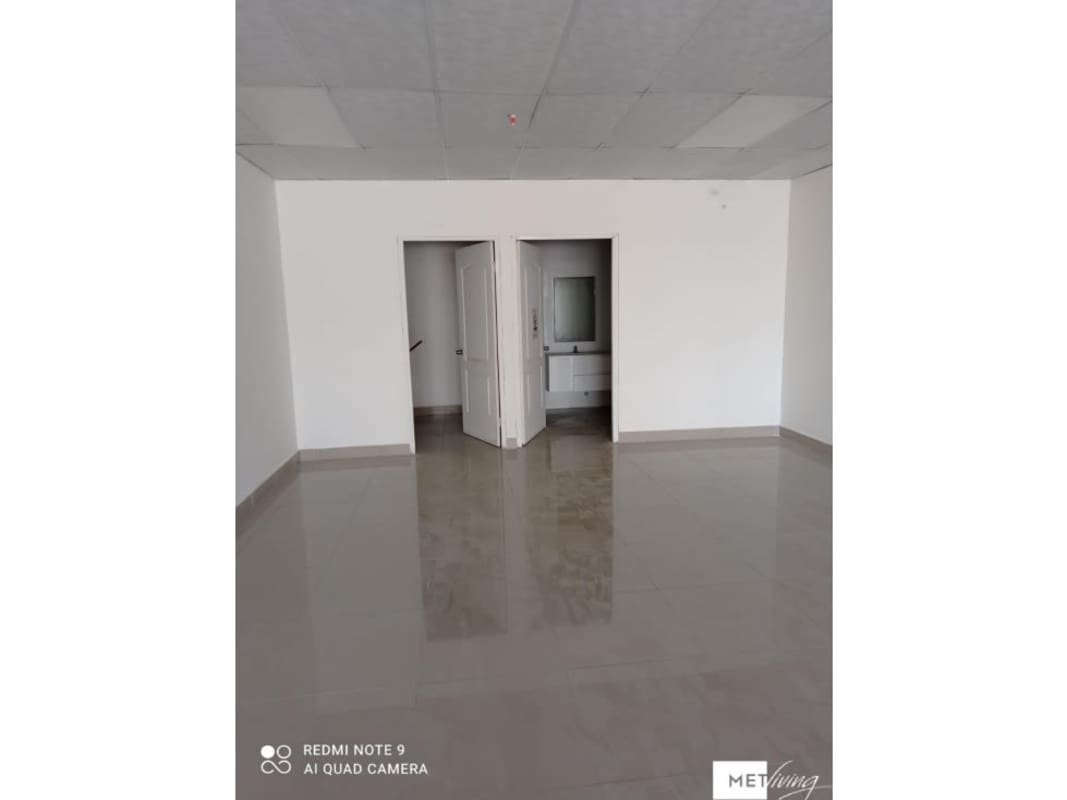 Empty retail interior with tiled floors and white walls in commercial property Centro Empresarial Tumba Muerto Panama