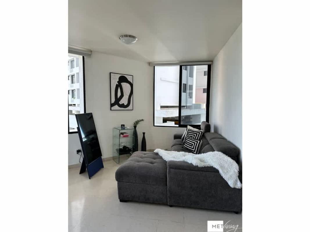 Bright living room with large corner windows, city views, minimalist design Pacific Hills Panama