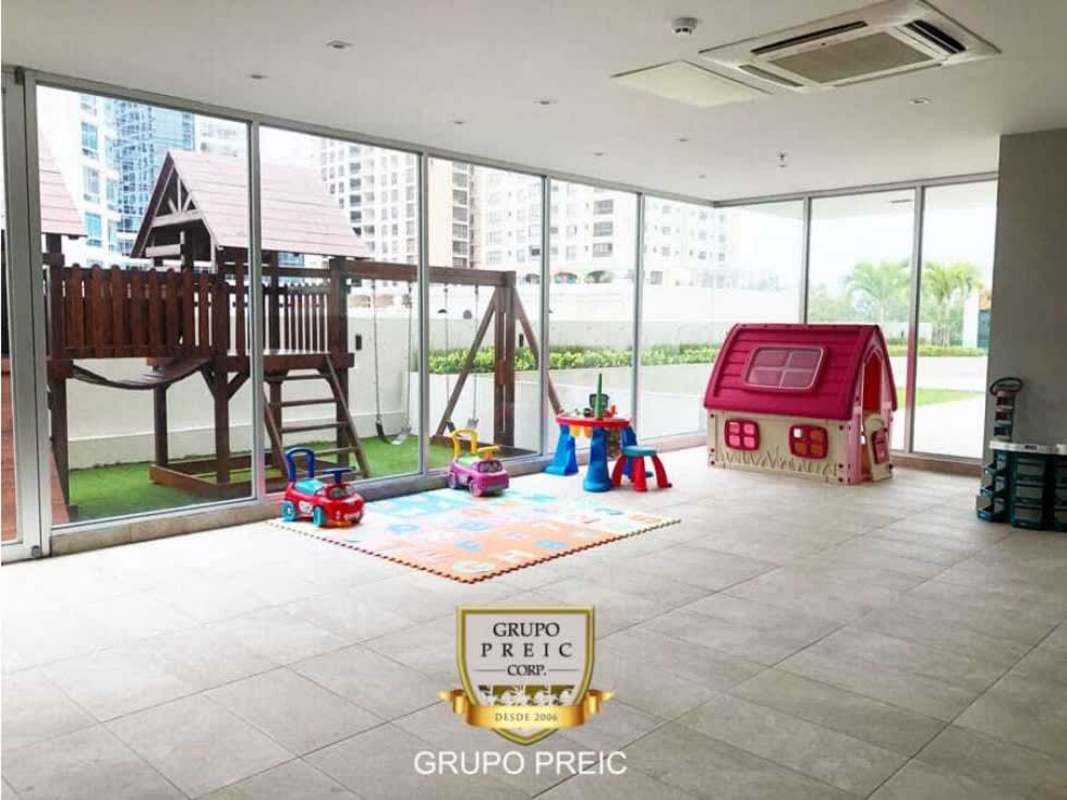 Modern open living area with balcony access and ocean skyline views in PH Lumiere Panama