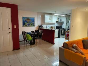 Open-plan dining area with modern kitchen granite counters in PH Albrook Park Panama