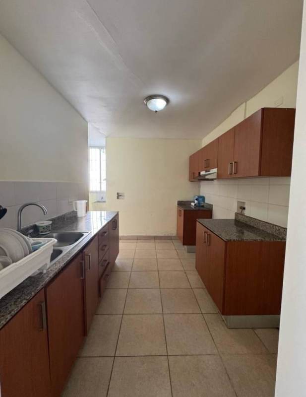 Modern kitchen with granite counters, wood cabinets, tiled floor PH Torre 88 El Dorado Panama City