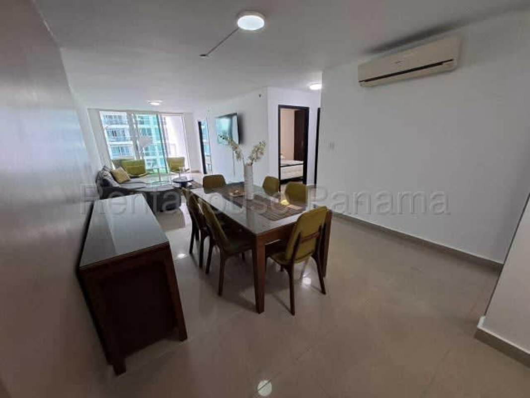 Spacious living room with large windows, balcony access, city view furnished Bella Vista Panama