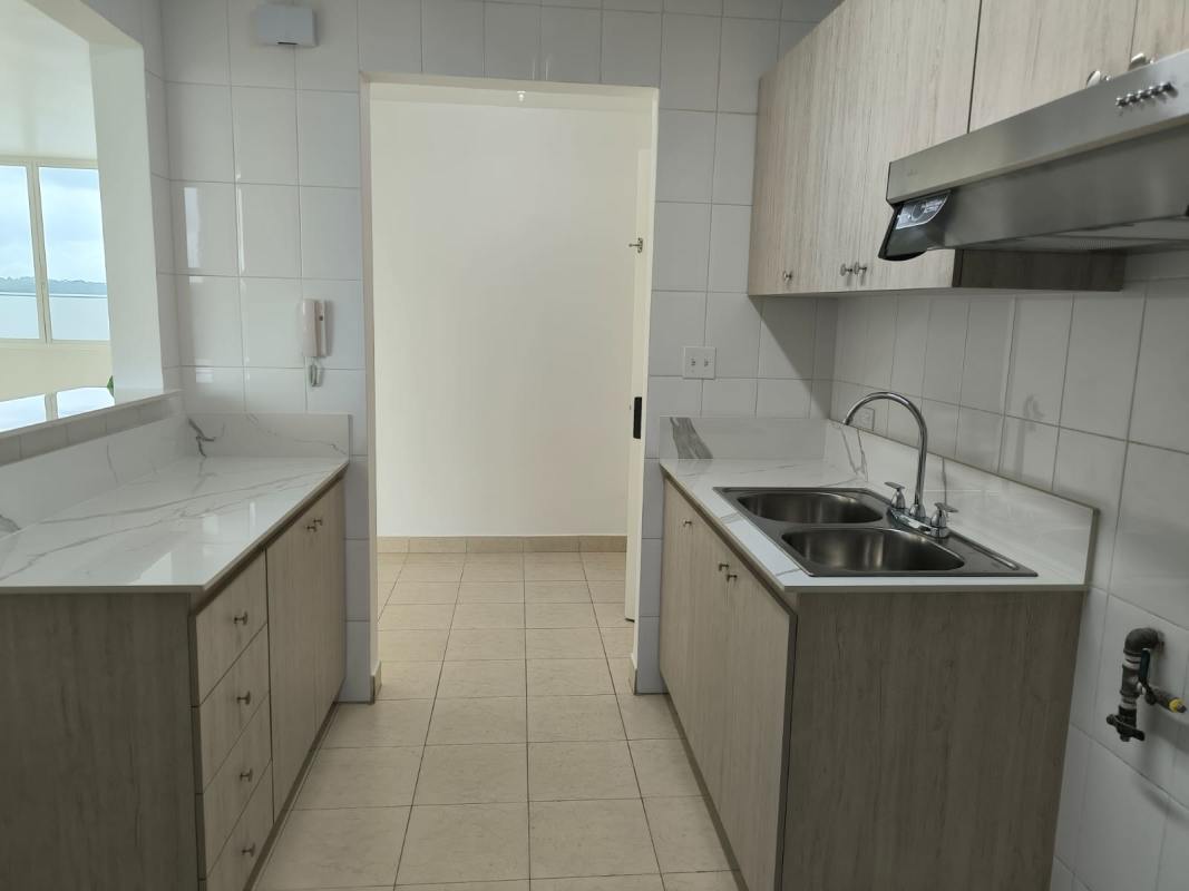 Bright apartment kitchen with large window marble countertop double sink Edison Park Panama