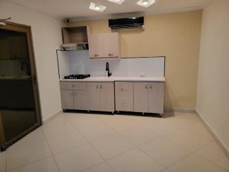 Minimalist open kitchen with breakfast bar, appliances, tile floors in Las Lajas Gardens Coronado Panama beach rental