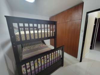 Small guest bedroom with bunk beds, built-in closet, tile floors in beach rental Las Lajas Gardens Coronado