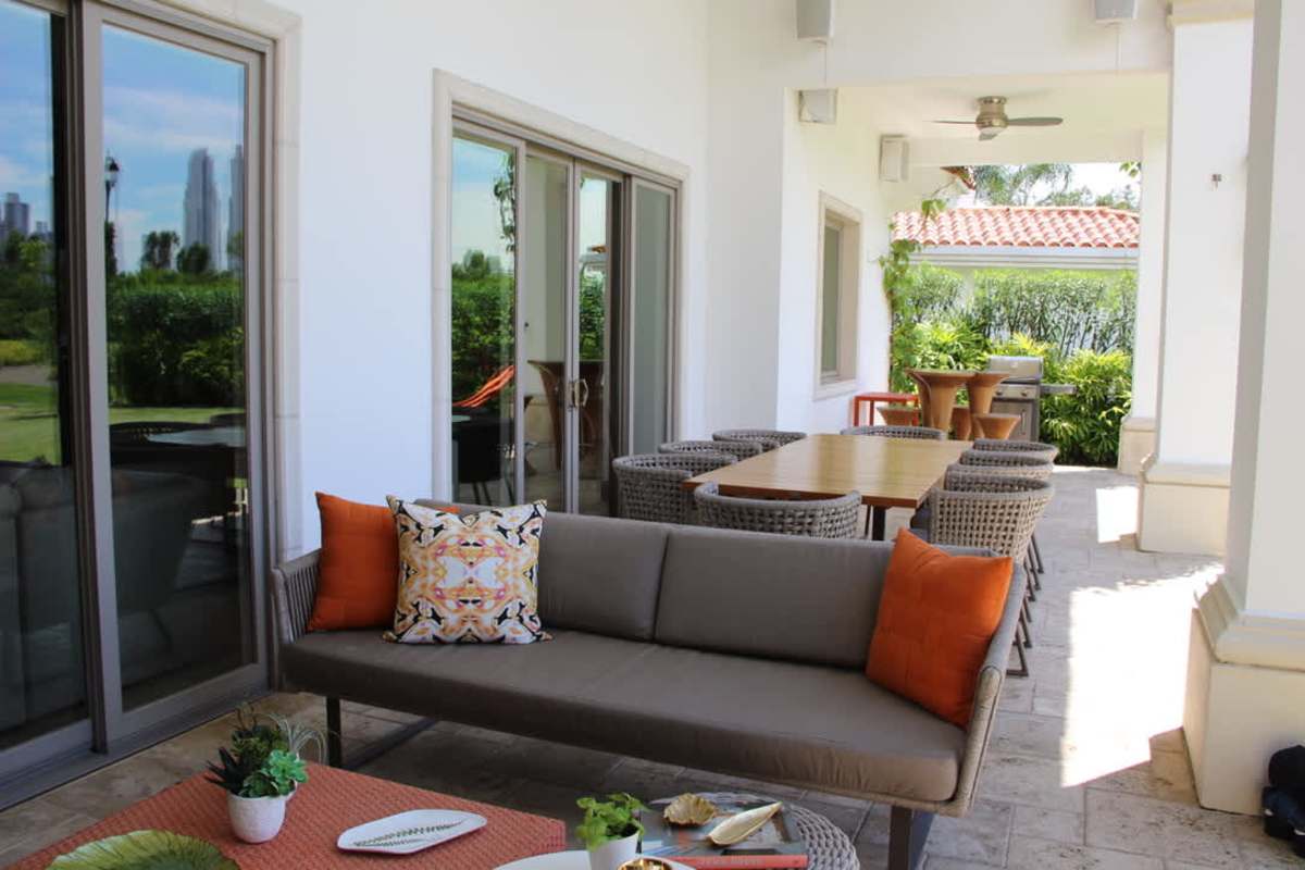 Mediterranean facade with terracotta roof, green lawn, lush landscaping in Santa María Golf Panama City