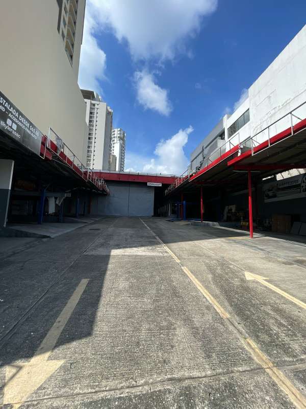 Wide paved loading dock area with warehouses and driveway near 12 de Octubre Panama City