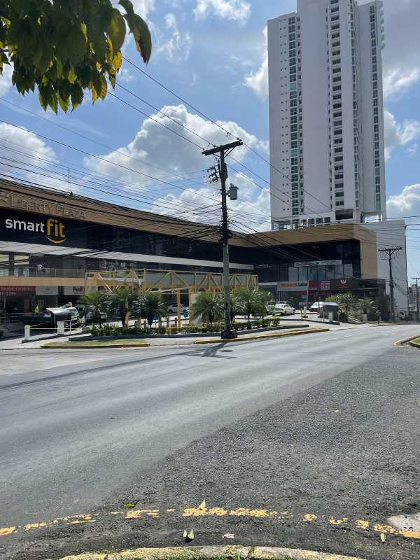 Commercial complex with shops and high-rise in background near 12 de Octubre Panama