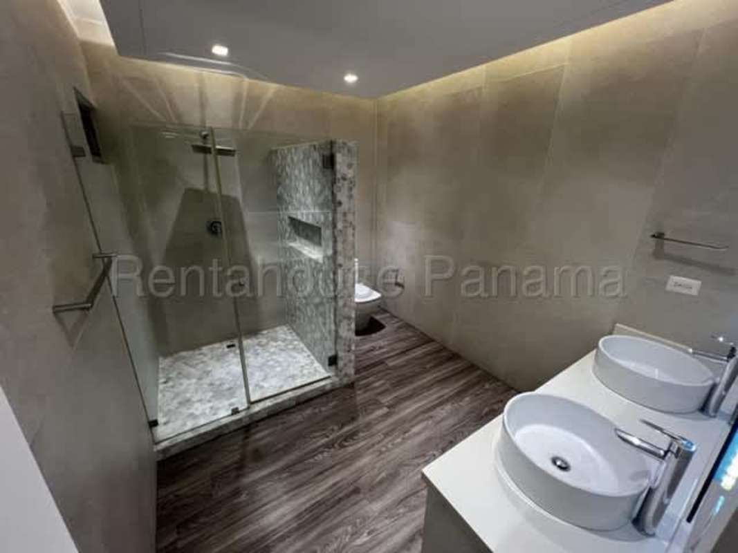 Large terrace overlooking Panama skyline and Pacific Ocean, glass railing in PH The Waterfront luxury condo Panama City