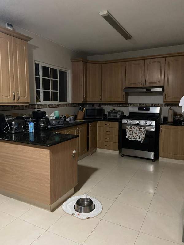 Contemporary living room with glass doors to terrace and pool in Costa Bay house Costa del Este Panama