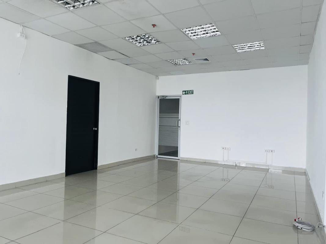 Modern office entryway with tiled flooring, lighting, and doors inside PH BICSA Tower