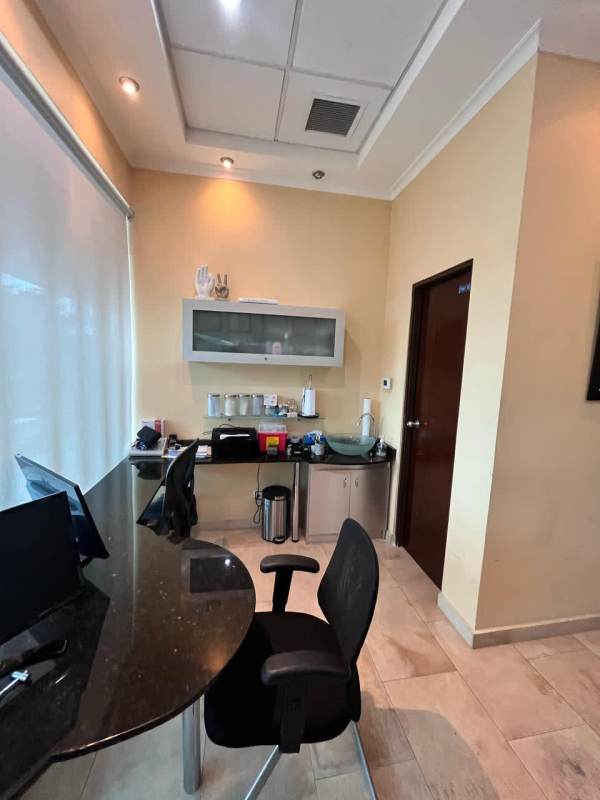 Private medical consultation room with granite counter and storage at Pacifica Salud Punta Pacífica