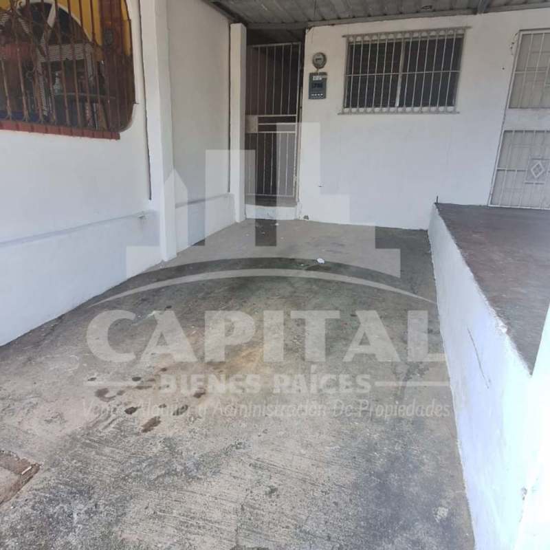 Covered parking area with metal bars and concrete driveway in Don Bosco house