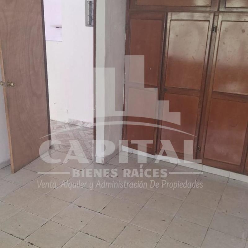 Spacious unfurnished interior with patterned tile floor and drop ceilings Don Bosco house
