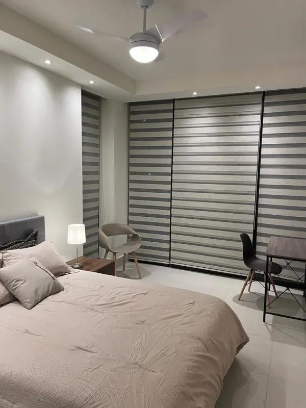 Bedroom with built-in desk space, large window blinds PH Coco Place Panama