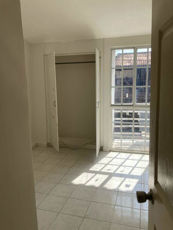 Bright bedroom with closet, ceramic floors, window in PH Mirador del Bosque townhouse rental Pacora Panama