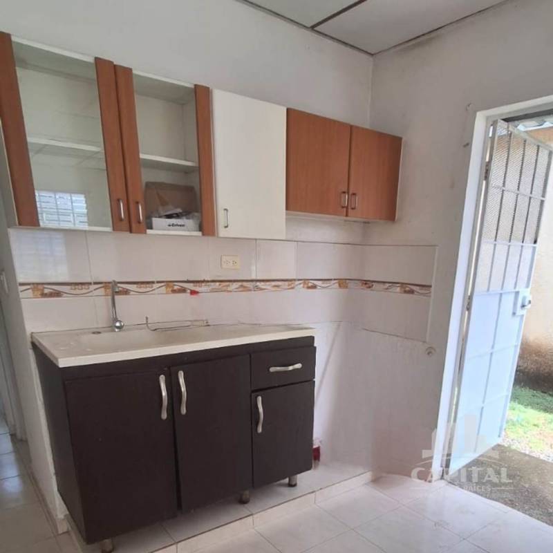 Compact kitchen with wooden cabinets and tile backsplash in home at La Riviera Don Bosco Panama