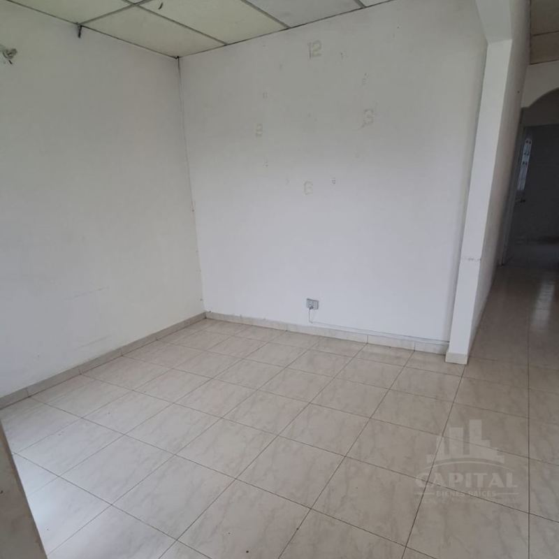 Unfurnished bedroom with white walls, window with security bars at La Riviera Don Bosco Panama City