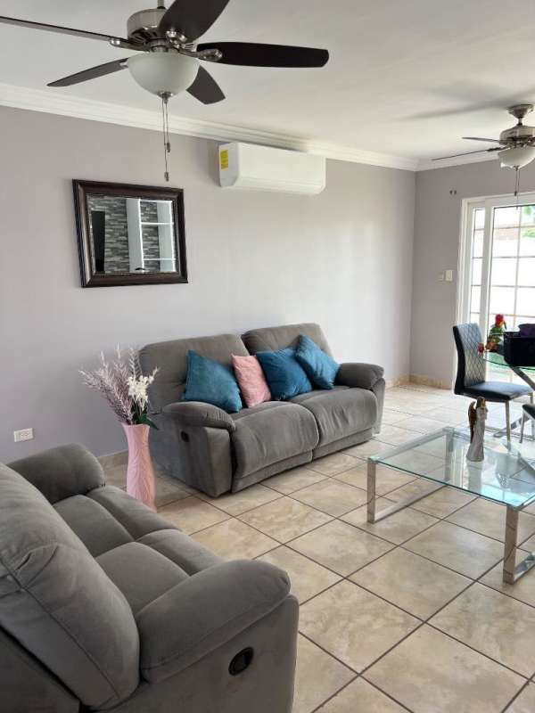 Bedroom with purple accent wall, AC, tile floors and modern furniture at PH Everest Panama City