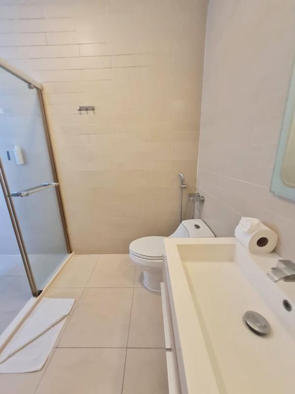 Open kitchen with granite counters, stainless appliances, breakfast bar in PH Waters Panama