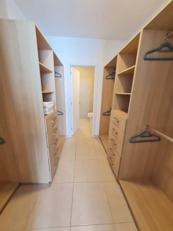 Walk-in closet with wood finish shelves and drawers PH Waters Panama