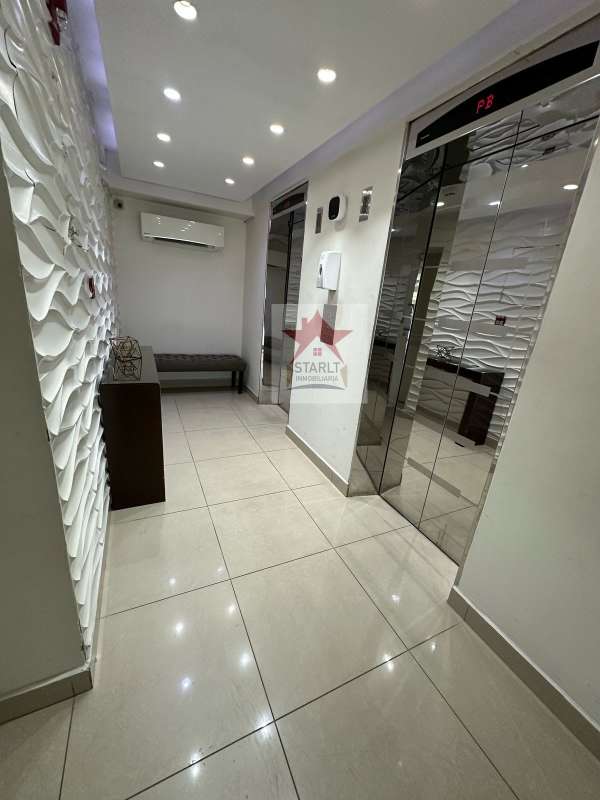 Contemporary kitchen with black granite counter and wood cabinets at Green Park Condado del Rey Panama