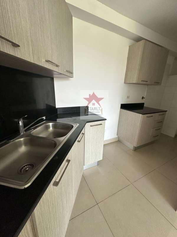 Empty living and dining area with tiled floors in apartment at Green Park Panama City