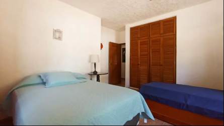 Rustic Mediterranean kitchen with wood cabinets, blue decorative backsplash, appliances and dining nook