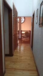 Dining room featuring wooden table, colorful wall art, terracotta walls and French doors