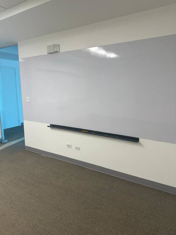 Private enclosed office within PH BICSA with glass walls, whiteboard wall, and modern design
