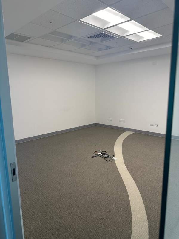 Spacious empty office with carpeting and drop ceiling, multiple electrical outlets in PH BICSA Tower Panama