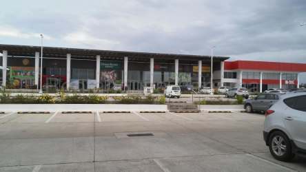 Commercial shopping plaza entrance with parking and signage at Uniplaza Costa Verde La Chorrera