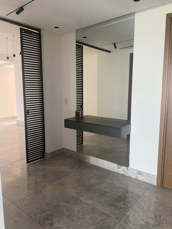 Spacious open-plan living with kitchen island and marble floors Empire Residences Santa María Panama