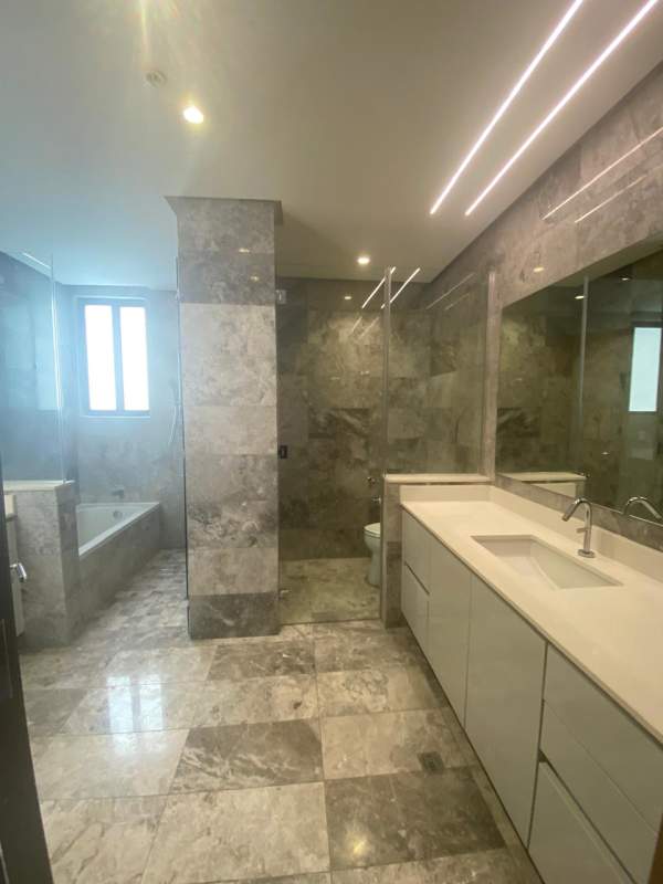 Luxury living space with marble flooring and large windows at Empire Residences Panama