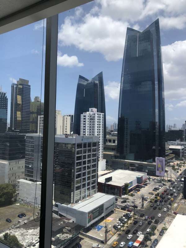 Corporate office interior with floor-to-ceiling glass windows and city views in PH BICSA Tower Panama City