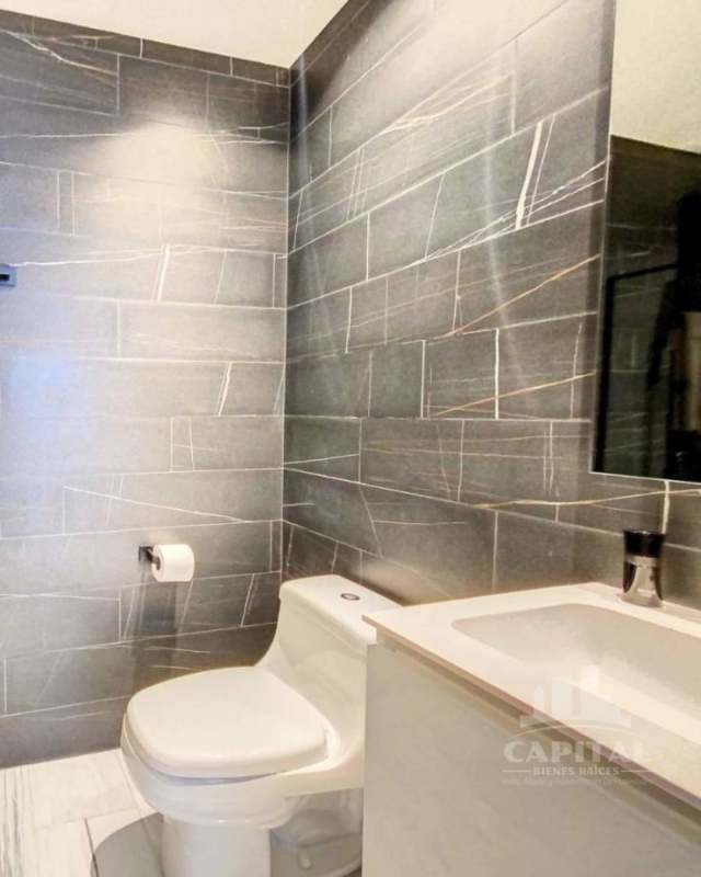 Sleek bathroom with glass shower and porcelain finishes in Marbella Tower Panama