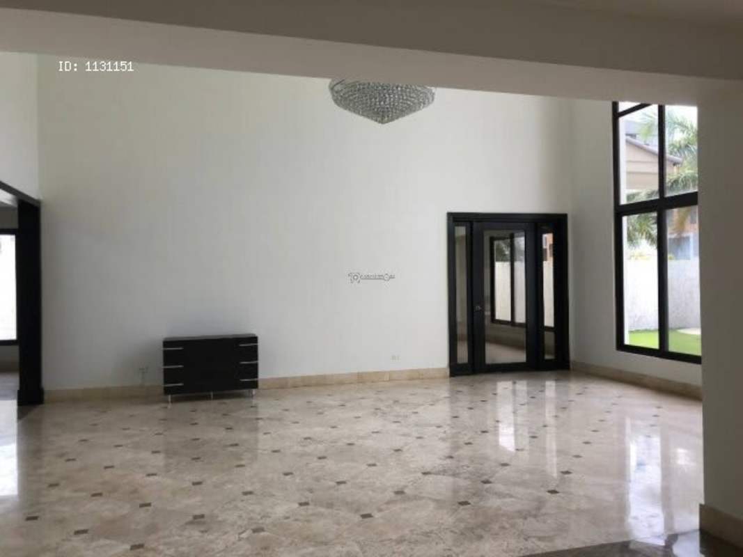 Outdoor covered terrace with ceiling fans overlooking private pool and garden in Costa del Este house