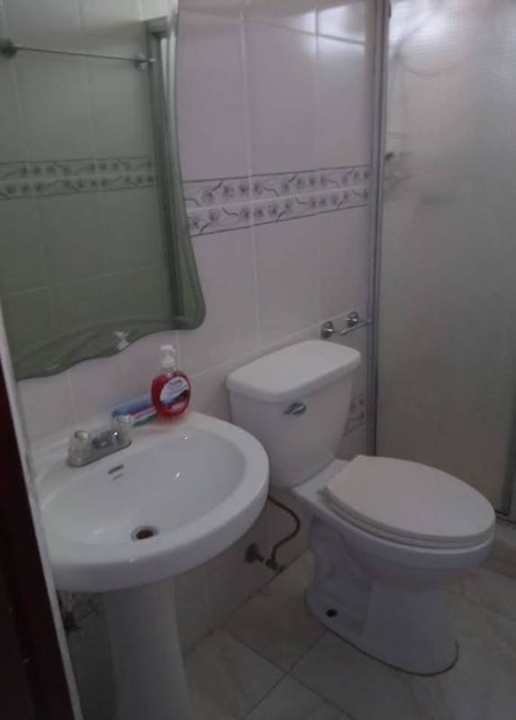 Small bathroom with sink, mirror and shower enclosure rent room Chanis Panama
