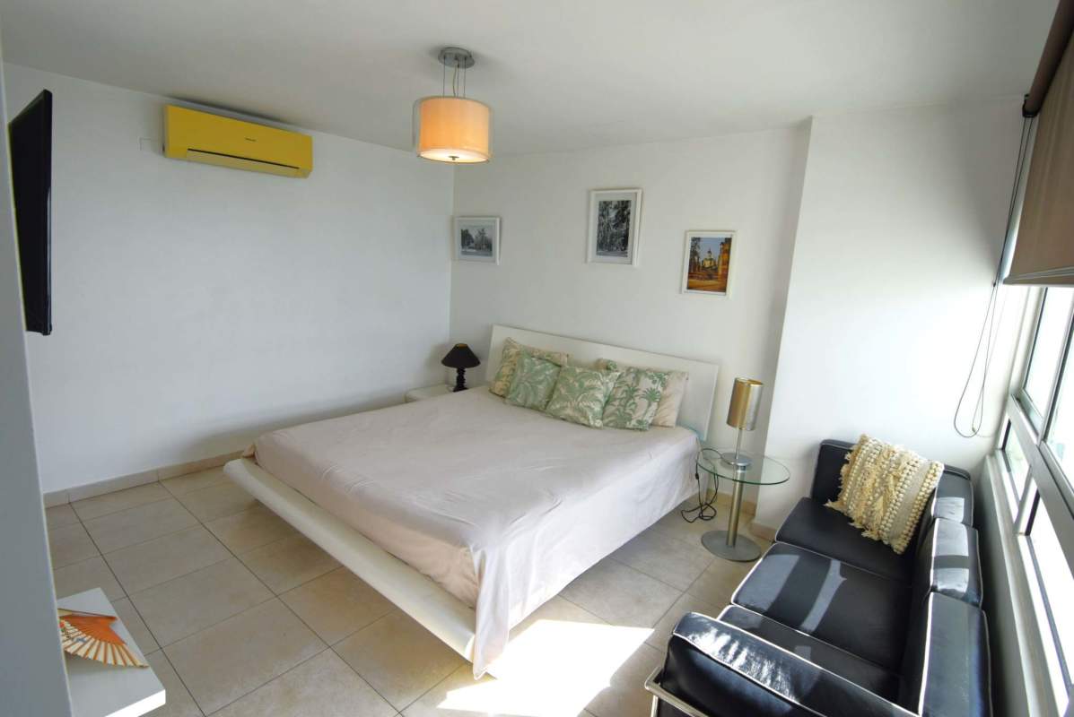 Bedroom with large window and ocean skyline views in PH Terrawind San Francisco Panama