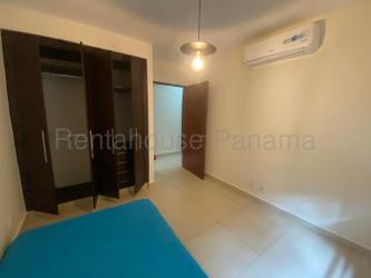 Outdoor swimming pool area in River Valley Panama Pacifico with lounge chairs and gardens