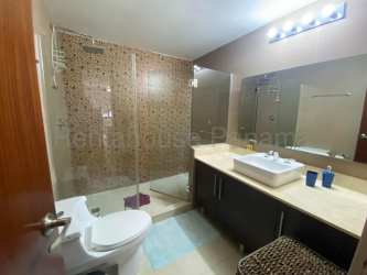 Living room with large windows, access to covered terrace overlooking greenery River Valley Panama Pacifico