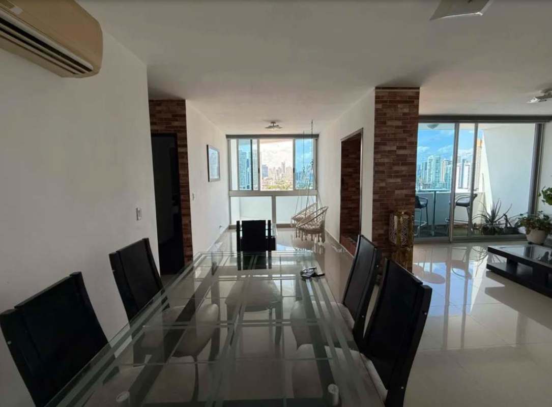 Modern dining and living space with large windows city skyline PH Infinity Tower