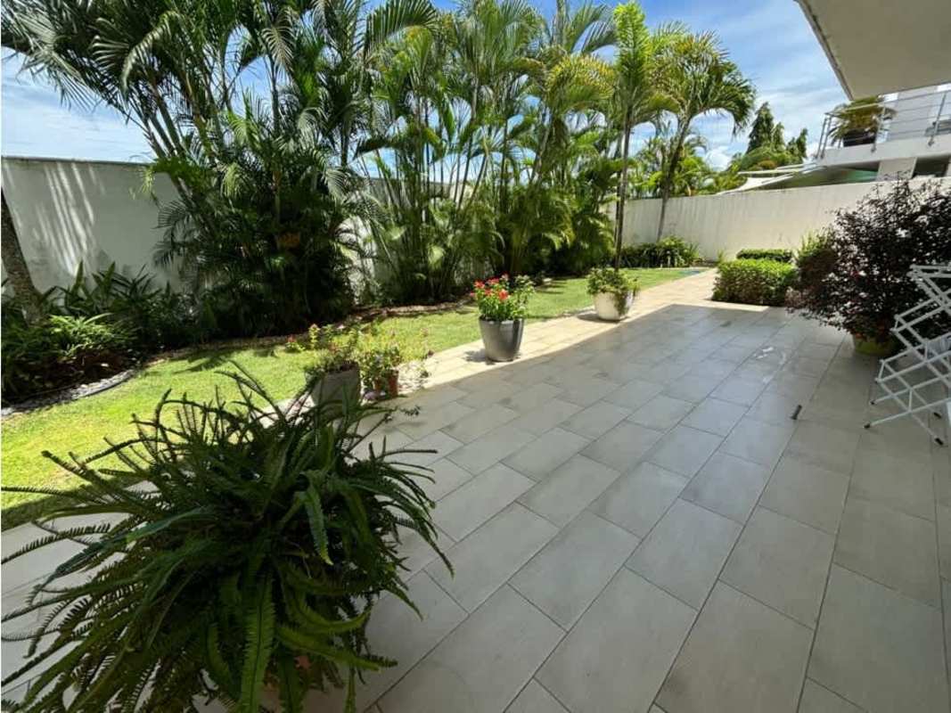 Lush green garden with tiled patio in Costa Esmeralda luxury house for sale Panama - Hola Realty