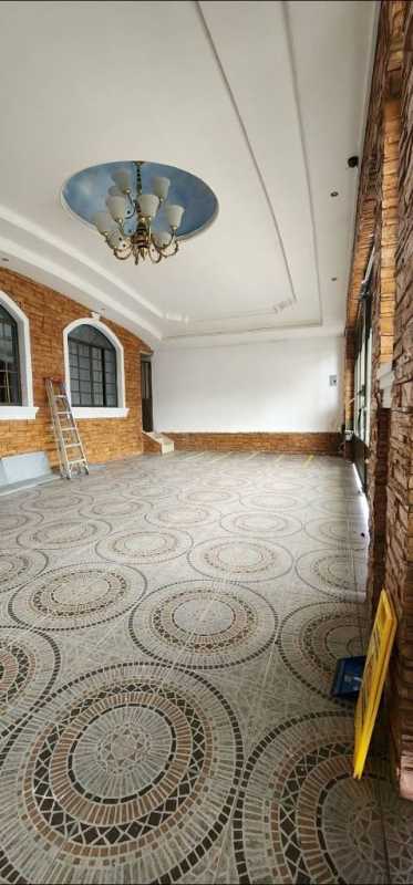 Spacious enclosed porch or sunroom with patterned tile, arched windows at Brisas del Golf home for rent