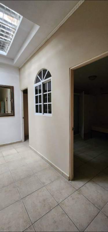 Interior hallway with skylight, arched interior window and tile flooring in Brisas del Golf rental Panama City