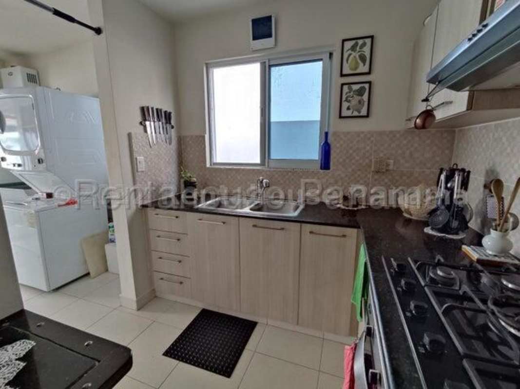 Kitchen with granite countertops, ceramic tiles and wooden cabinetry at Costa Verde House La Chorrera
